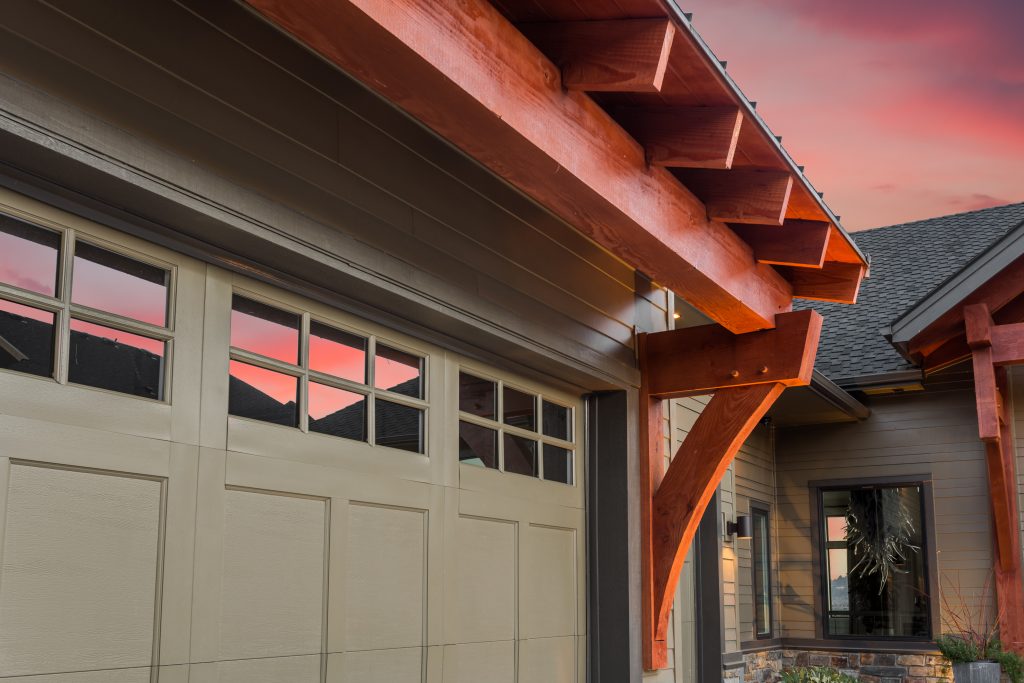 Garage Door with Partial View of Front Entrance and Colorful Sunset Sky