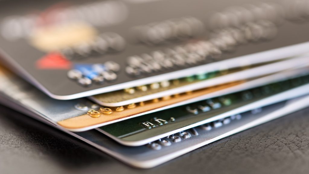 Credit card close-up. Credit card pile. Plastic card on black background, 